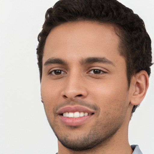 Joyful white young-adult male with short  black hair and brown eyes