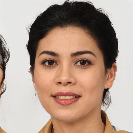 Joyful latino young-adult female with medium  brown hair and brown eyes