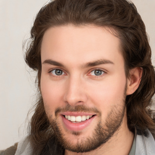 Joyful white young-adult male with medium  brown hair and brown eyes