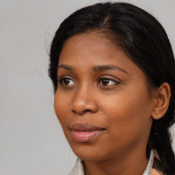 Joyful black young-adult female with medium  brown hair and brown eyes