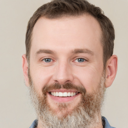 Joyful white adult male with short  brown hair and grey eyes