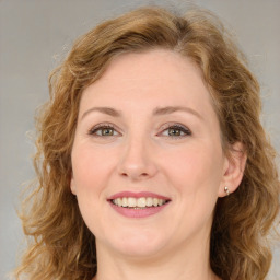 Joyful white adult female with long  brown hair and green eyes