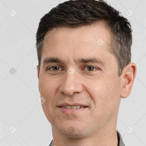 Joyful white adult male with short  brown hair and brown eyes