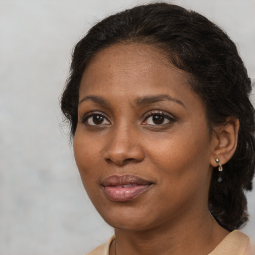 Joyful black adult female with medium  brown hair and brown eyes