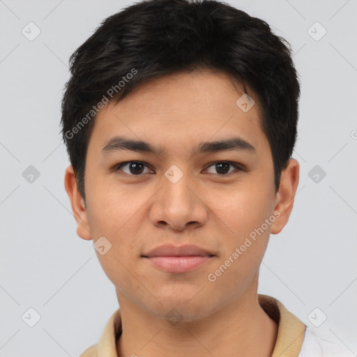 Joyful latino young-adult male with short  brown hair and brown eyes