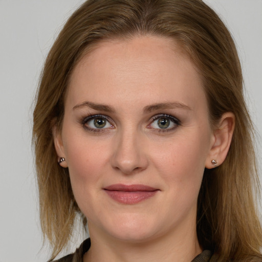 Joyful white young-adult female with long  brown hair and blue eyes