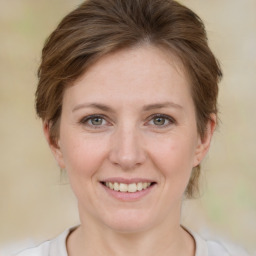 Joyful white young-adult female with medium  brown hair and green eyes