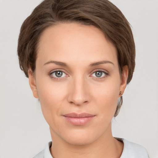 Joyful white young-adult female with short  brown hair and grey eyes