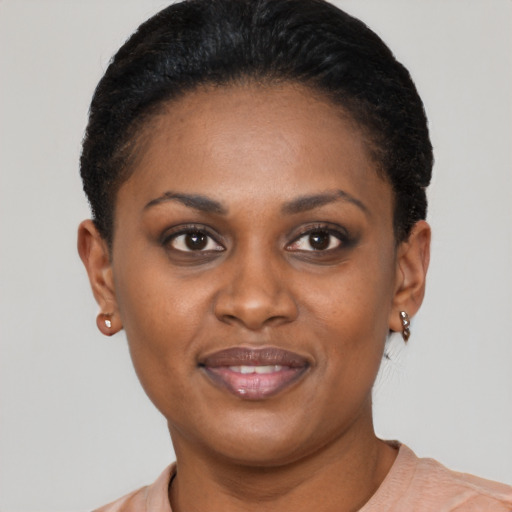Joyful black young-adult female with short  brown hair and brown eyes