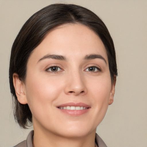 Joyful white young-adult female with medium  brown hair and brown eyes