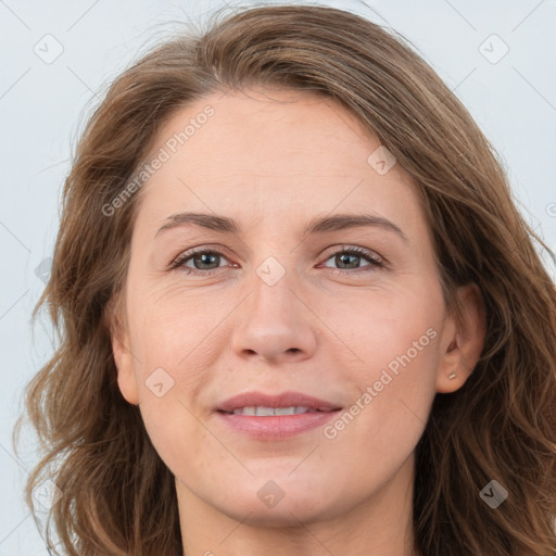 Joyful white adult female with long  brown hair and grey eyes