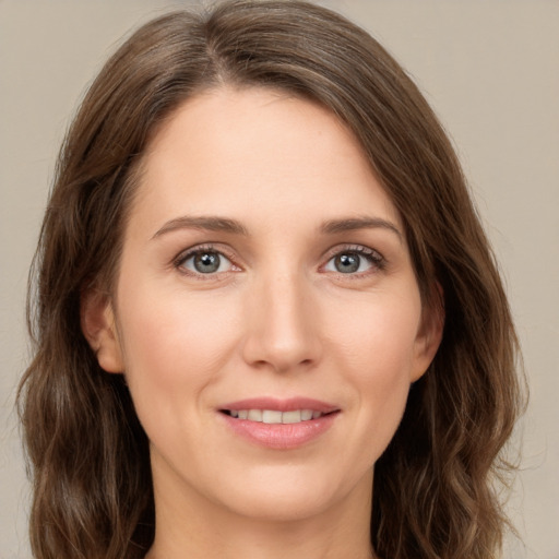 Joyful white young-adult female with long  brown hair and green eyes