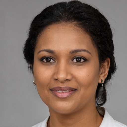 Joyful black young-adult female with medium  brown hair and brown eyes