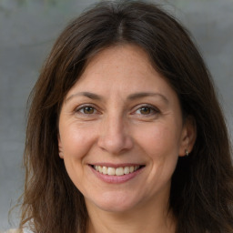 Joyful white adult female with medium  brown hair and brown eyes