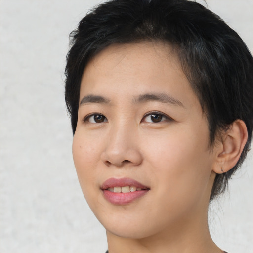Joyful asian young-adult female with medium  brown hair and brown eyes