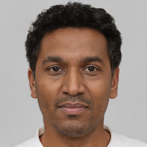 Neutral latino adult male with short  black hair and brown eyes