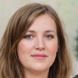 Joyful white young-adult female with medium  brown hair and green eyes