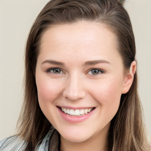 Joyful white young-adult female with long  brown hair and blue eyes