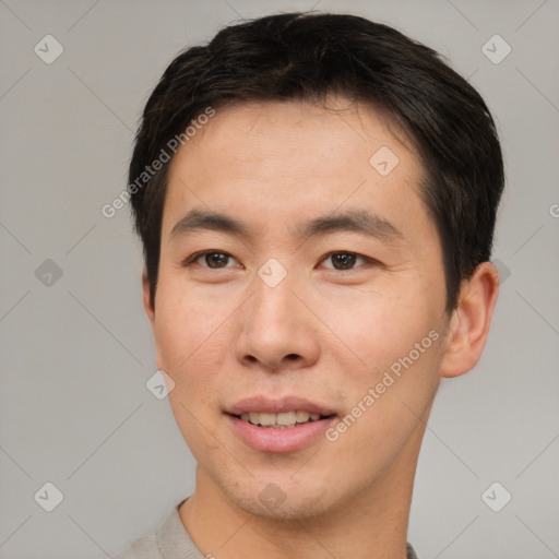 Joyful asian young-adult male with short  brown hair and brown eyes