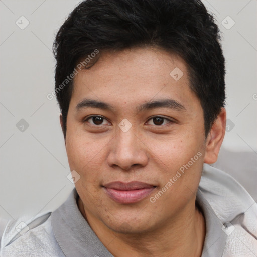 Joyful asian young-adult male with short  brown hair and brown eyes