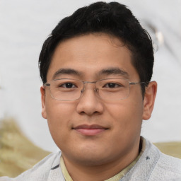 Joyful asian young-adult male with short  brown hair and brown eyes