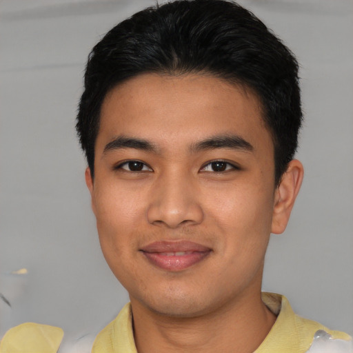Joyful asian young-adult male with short  black hair and brown eyes