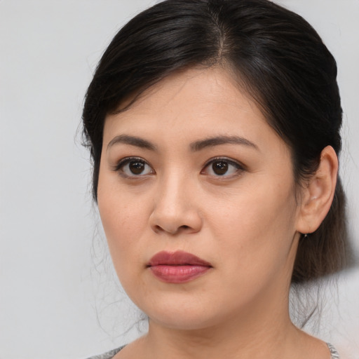 Joyful asian young-adult female with medium  brown hair and brown eyes