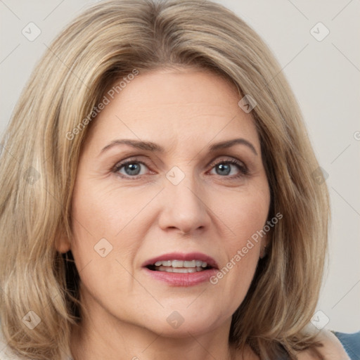 Joyful white adult female with medium  brown hair and grey eyes