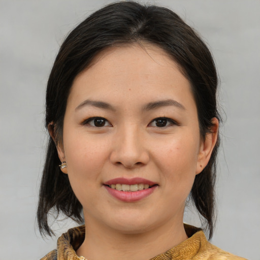 Joyful asian young-adult female with medium  brown hair and brown eyes