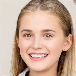 Joyful white young-adult female with long  brown hair and blue eyes