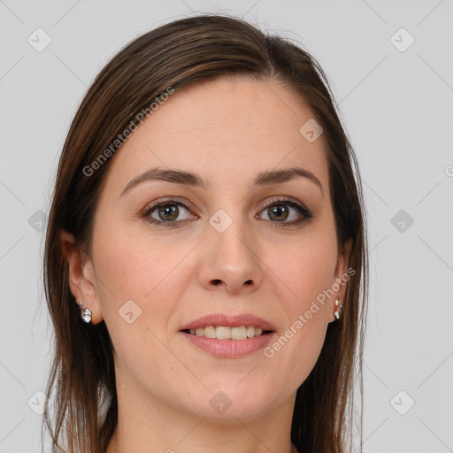 Joyful white young-adult female with long  brown hair and brown eyes