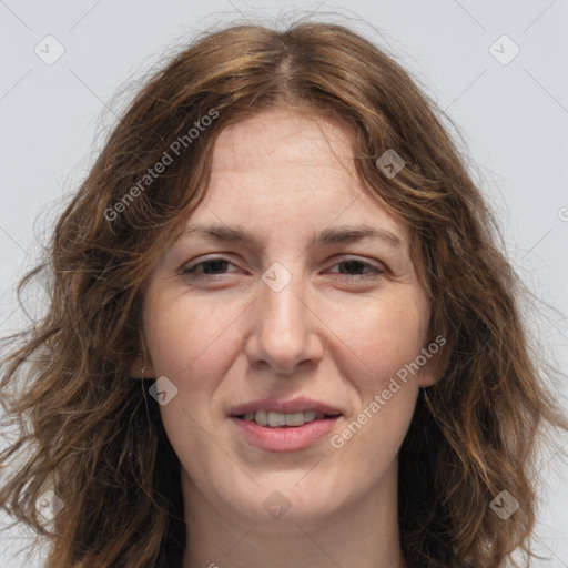 Joyful white adult female with long  brown hair and grey eyes