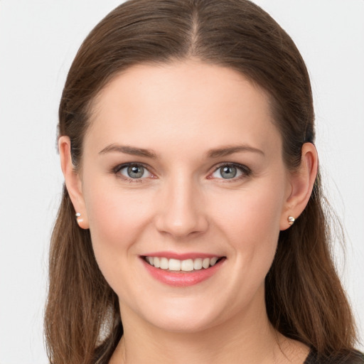 Joyful white young-adult female with long  brown hair and grey eyes