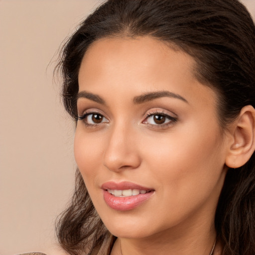 Joyful white young-adult female with long  brown hair and brown eyes