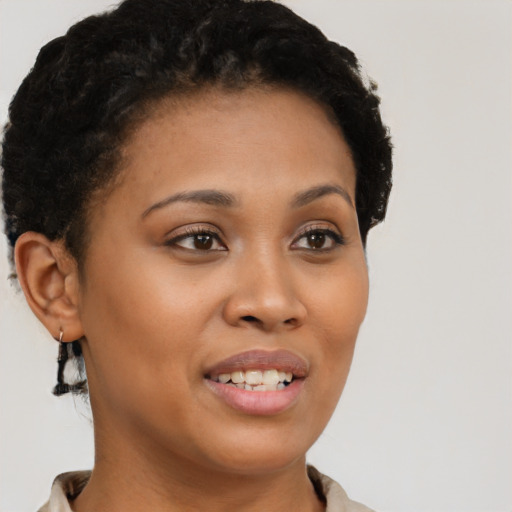 Joyful black young-adult female with short  brown hair and brown eyes