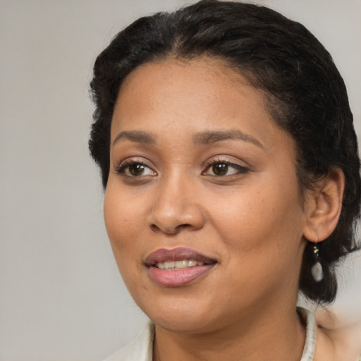 Joyful black young-adult female with medium  black hair and brown eyes
