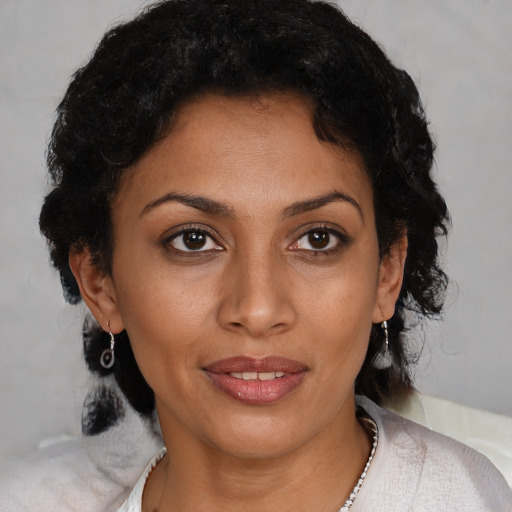 Joyful black young-adult female with medium  black hair and brown eyes