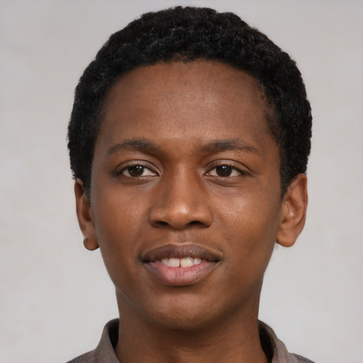 Joyful black young-adult male with short  black hair and brown eyes