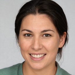 Joyful white adult female with medium  brown hair and brown eyes