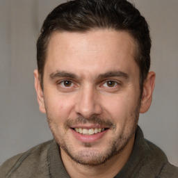 Joyful white adult male with short  brown hair and brown eyes