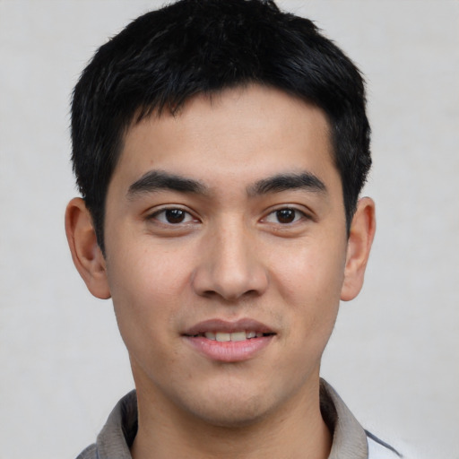 Joyful asian young-adult male with short  black hair and brown eyes