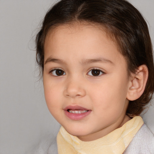 Joyful white child female with medium  brown hair and brown eyes