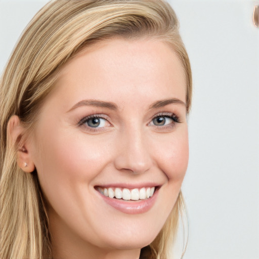 Joyful white young-adult female with long  brown hair and blue eyes