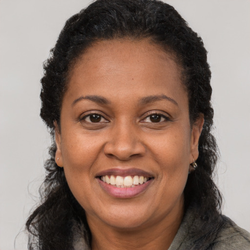 Joyful latino adult female with long  brown hair and brown eyes