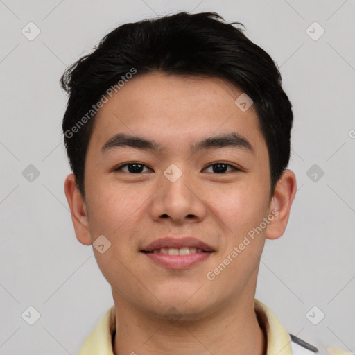 Joyful asian young-adult male with short  black hair and brown eyes