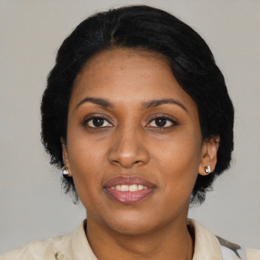 Joyful black adult female with medium  black hair and brown eyes