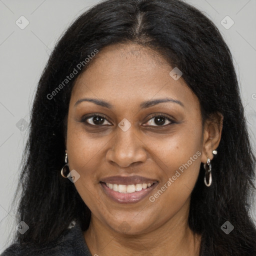 Joyful black young-adult female with long  brown hair and brown eyes