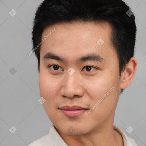 Joyful asian young-adult male with short  brown hair and brown eyes