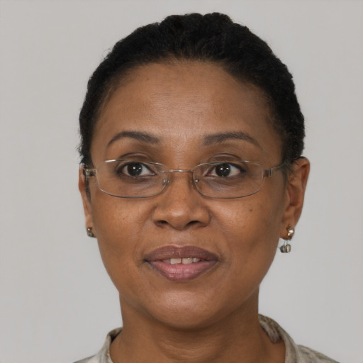 Joyful black adult female with short  brown hair and brown eyes