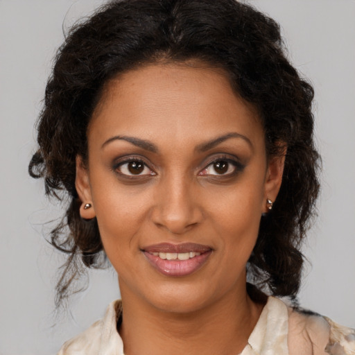 Joyful black young-adult female with medium  brown hair and brown eyes